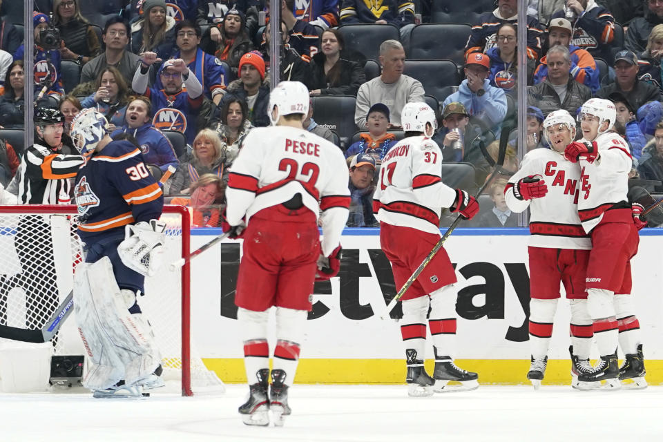 New York Islanders goaltender Ilya Sorokin (30) reacts as Carolina Hurricanes center Paul Stastny, second from right, celebrates after scoring during the second period of an NHL hockey game, Saturday, Dec. 10, 2022, in Elmont, N.Y. (AP Photo/Mary Altaffer)