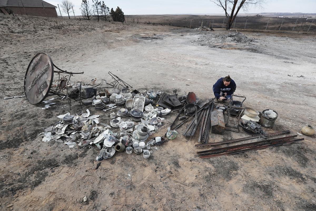 Brooke McQuiddy looks through some of her mother, Melanie McQuiddy’s possessions recovered from the property. Melanie McQuiddy’s mobile home was on the lot in the background when the fire swept through. Canadian, Tx. residents were cleaning up and recovering from the massive wild fires that burned much of the northern Texas panhandle.