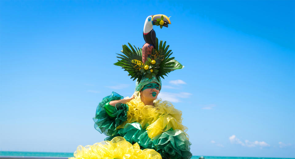 Person in colourful costume on Brighton beach for Pride