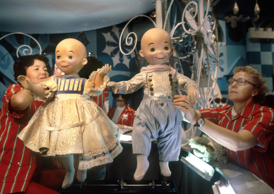 Disney employees handle the dolls for the "It's a Small World" exhibit.