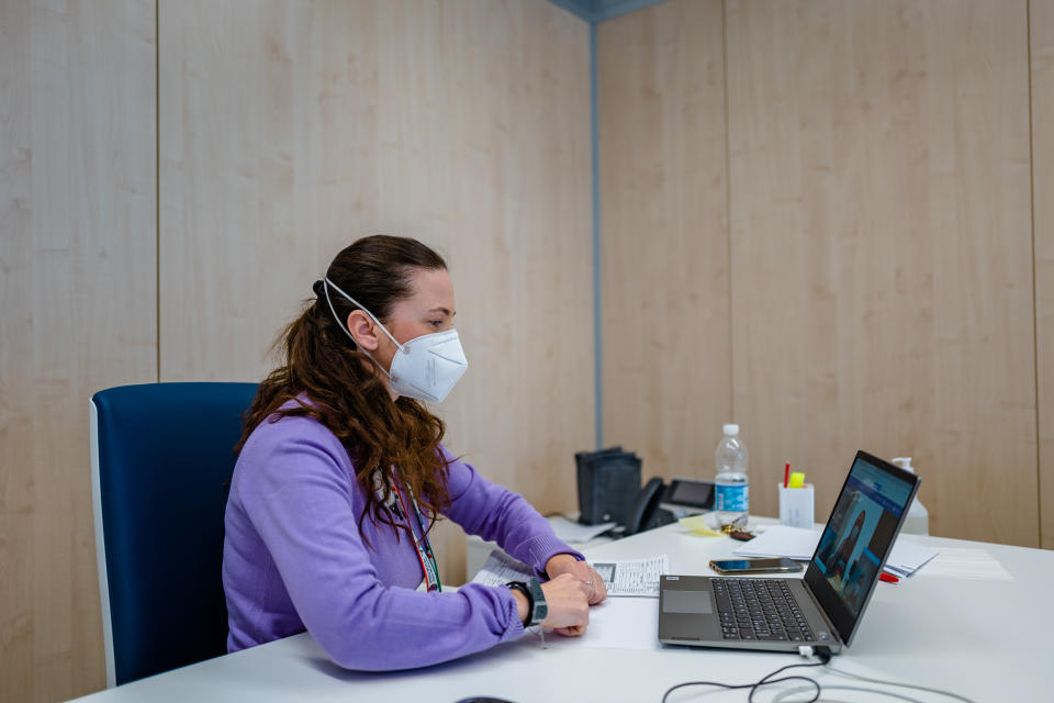 A doctor in her office in speaking to a COVID patient via video on a laptop. (Source: AP)