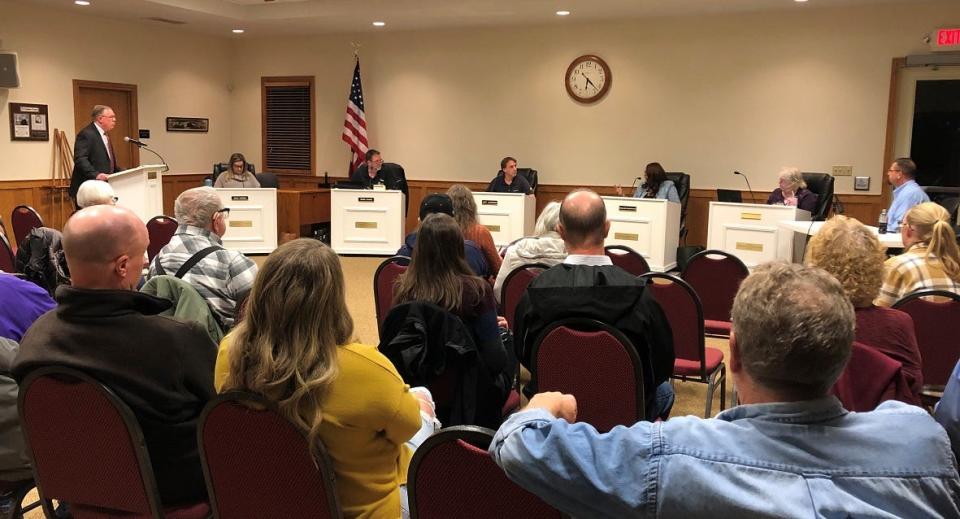 Etna Township residents listen to Kevin Wolfe, a loss prevention executive with the private investigations firm WhereWolfe Intelligence, as his findings of looking into the township security camera system during the Dec. 6 Etna Township Trustee meeting.