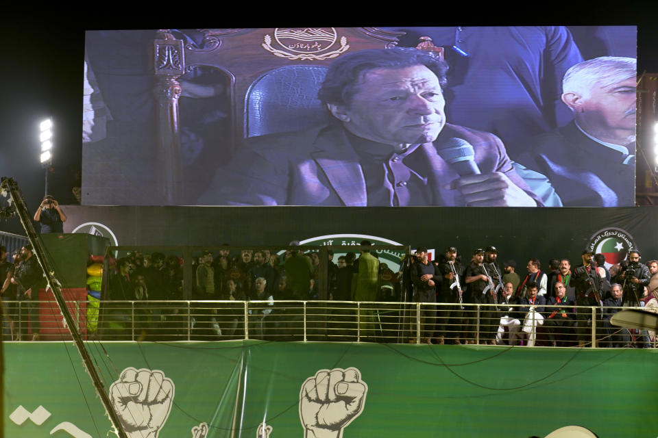 Pakistan's former Prime Minister and opposition leader Imran Khan addresses to his supporters during a rally, in Rawalpindi, Pakistan, Saturday, Nov. 26, 2022. Khan said Saturday his party was quitting the country's regional and national assemblies, as he made his first public appearance since being wounded in a gun attack earlier this month. (AP Photo/Anjum Naveed)