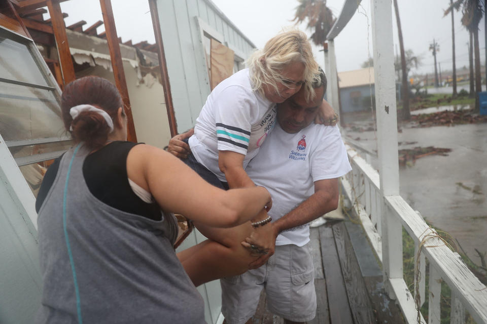 Donna Raney is helped out of the window by Lee Guerrero and Daisy Graham in Rockport.