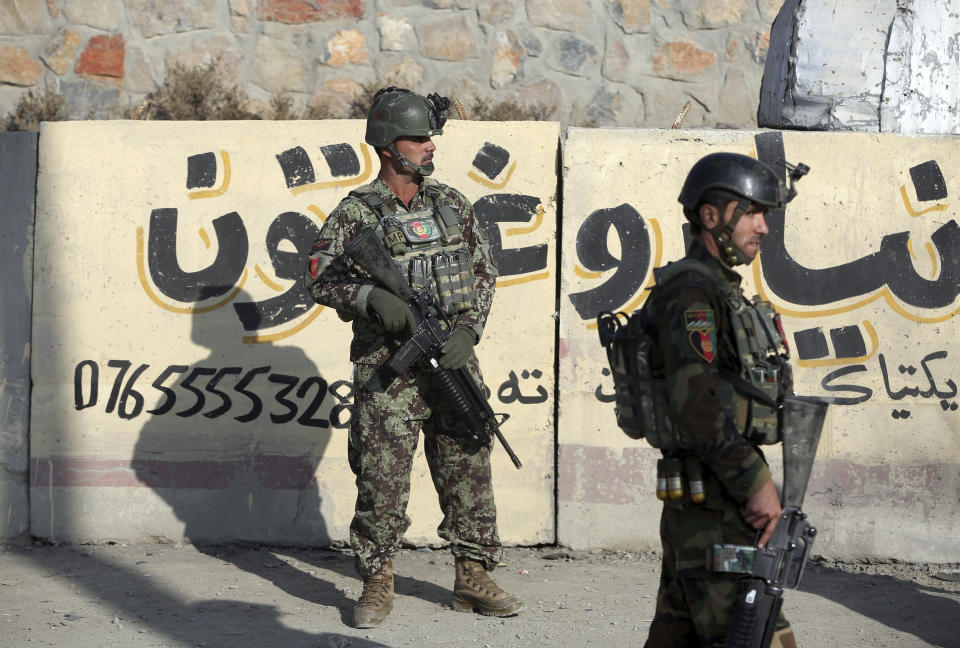 National army soldiers stand guard in front of the Kabul Military Training Center in Kabul, Afghanistan, Monday, Nov. 18, 2019. Back-to-back explosions early Monday targeting the military training center wounded Afghan national army soldiers, police and interior spokesmen said. (AP Photo/Rahmat Gul)