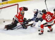 Apr 1, 2019; Chicago, IL, USA; Winnipeg Jets right wing Kevin Hayes (12) scores the game winning goal in overtime past Chicago Blackhawks goaltender Corey Crawford (50) at United Center. Mandatory Credit: Nuccio DiNuzzo-USA TODAY Sports