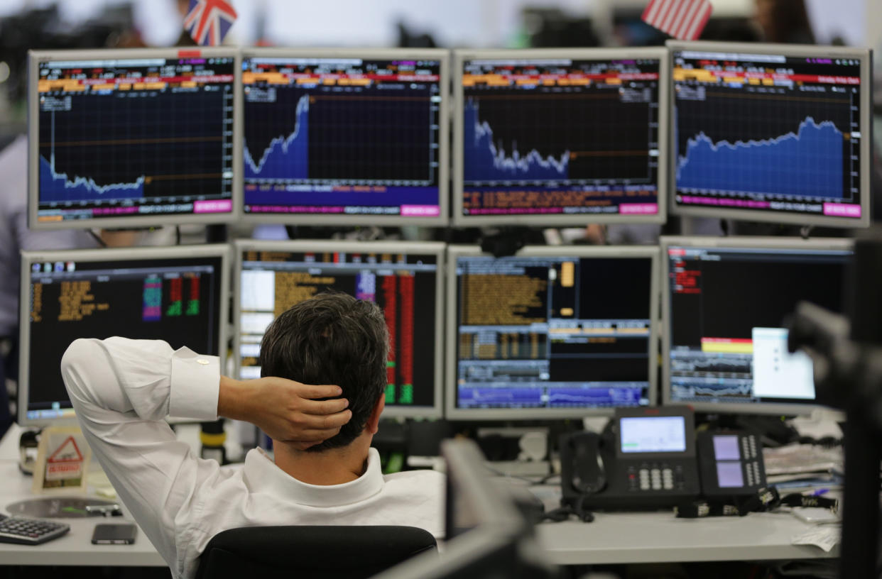 Traders from ETX Capital work in central london on June 27, 2016. Shares in banks, airlines and property companies plunged on the London stock exchange Monday as investors singled out the three sectors as being the most vulnerable to Britain's decision to leave the EU. / AFP / Daniel Leal-Olivas        (Photo credit should read DANIEL LEAL-OLIVAS/AFP/Getty Images)