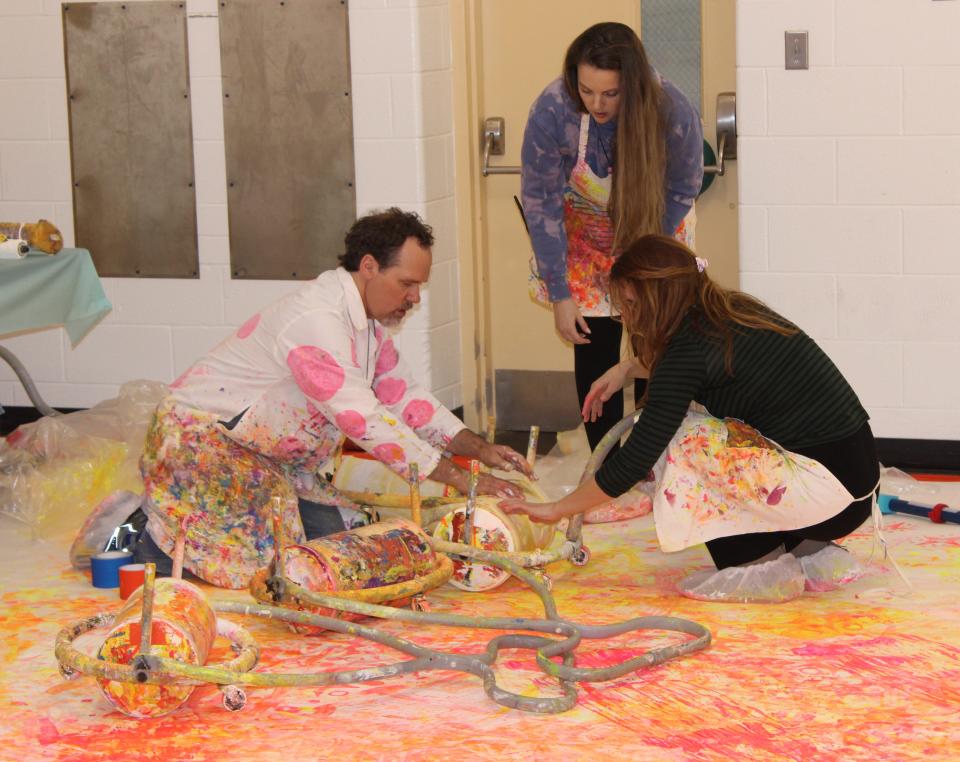 Kalamazoo artist Dwayne Szot, left, with help from Monroe County Intermediate School District employees Caitlin Palm and Shawna Dippman, prepare art rollers for students to paint with.