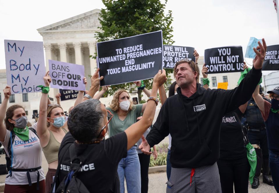 Pro-choice and anti-abortion activists protest alongside each other during a demonstration outside of the Supreme Court on October 04, 2021.