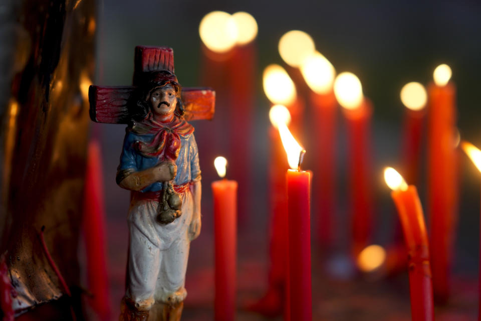 A figure of Argentina's folk Saint "Gauchito" Gil is surrounded by candles at his sanctuary in Mercedes Corrientes, Argentina, Saturday, Jan. 6, 2024. Every Jan. 8, devotees from across the country visit his sanctuary to ask for miracles or give him thanks. (AP Photo/Natacha Pisarenko)