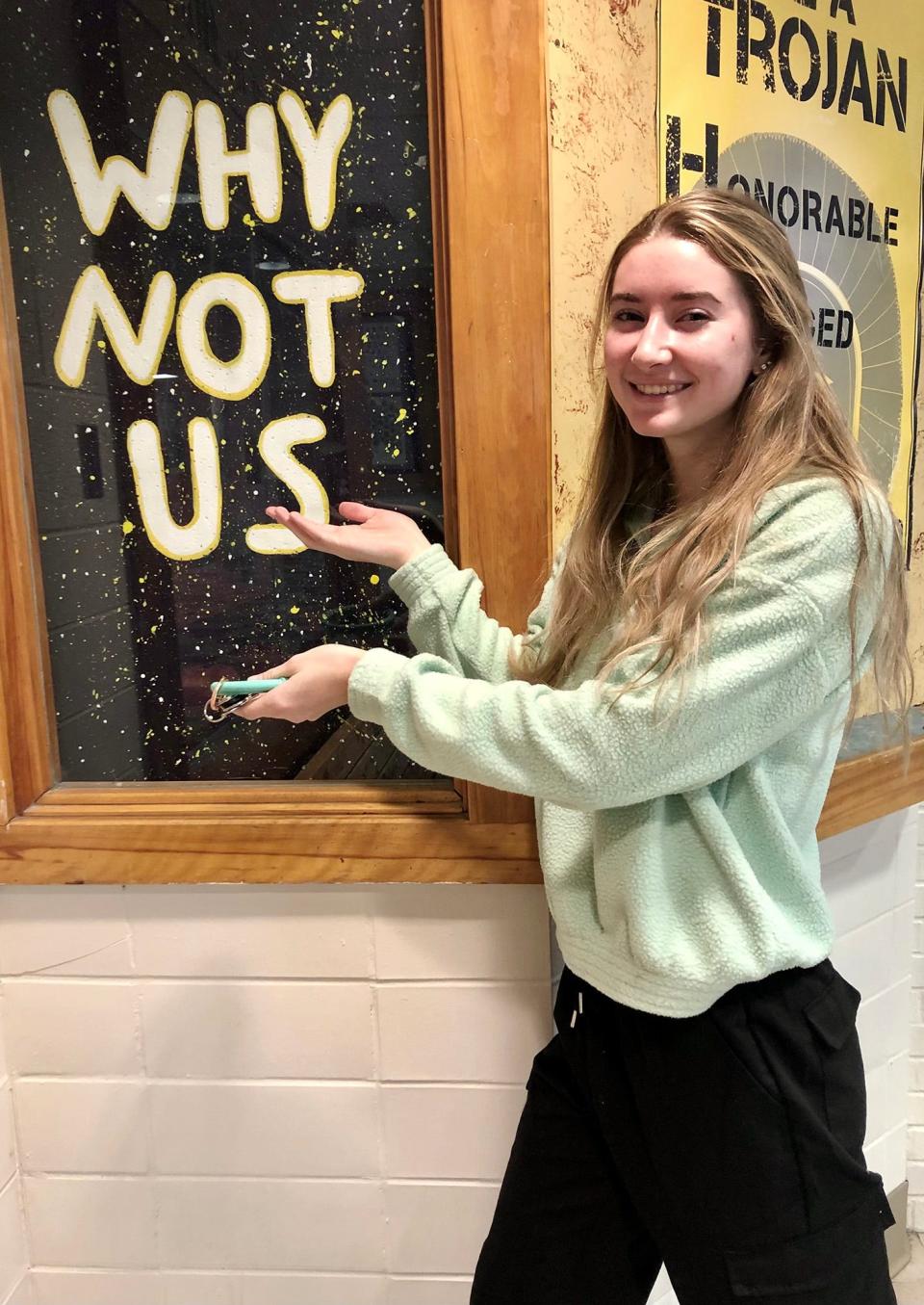 Alexandria "Alex" Verner, a junior at Michigan State University who graduated from Clawson High School in 2020. She is shown here with an art piece she created for the front of the school building.