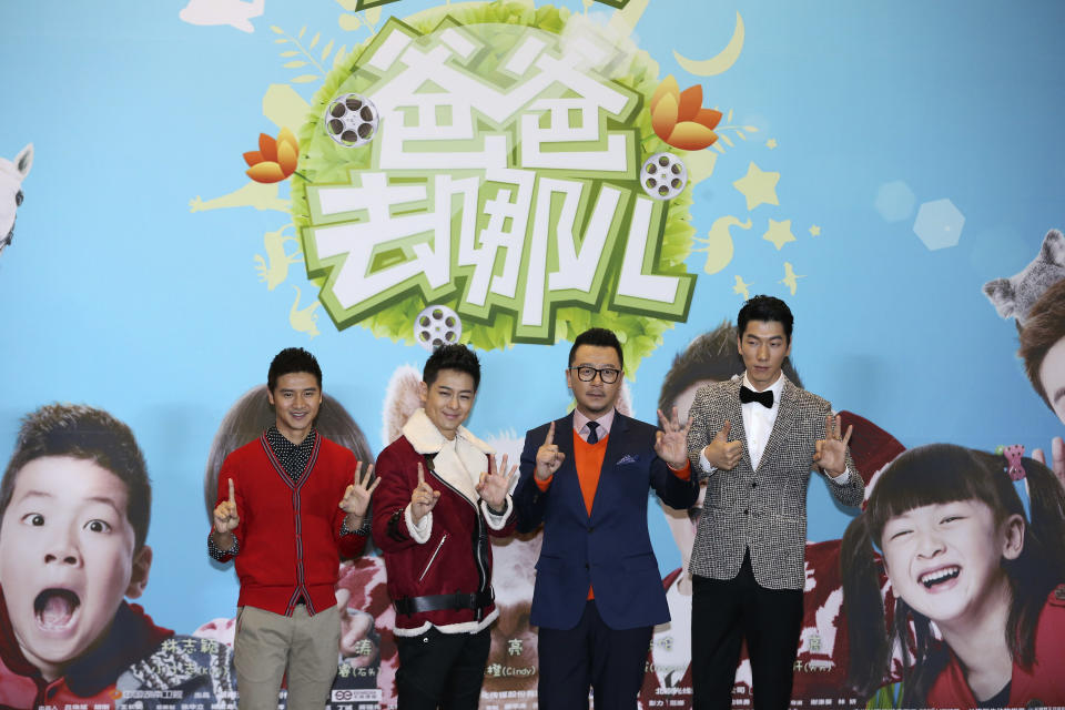 In this Jan. 25, 2014 photo, actors, from left to right, Tian Liang, Jimmy Lin, Guo Tao, and Zhang Liang, pose for photos at a press conference for movie “Dad, Where Are We Going?” in Beijing, China. The movie about the relationships between celebrity fathers and their young children is the latest Chinese TV program to attempt to cross over onto the big screen, as entertainment companies try to capitalize on the success of hit shows. (AP Photo) CHINA OUT