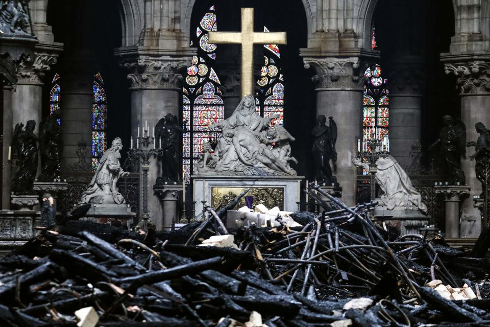 The main altar in Notre Dame Cathedral surrounded by charred debris on April 16, 2019. A white marble Pieta seems to have survived a devastating fire on April 15.