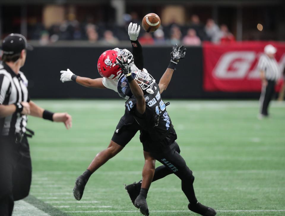 Savannah Christian's Kenry Wall attempts to make a reception over Cedar Grove's D'Marcus Clements during the GHSA Class 3A State Championship game on Wednesday, December 13, 2023 at Mercedes-Benz Stadium in Atlanta, Georgia.