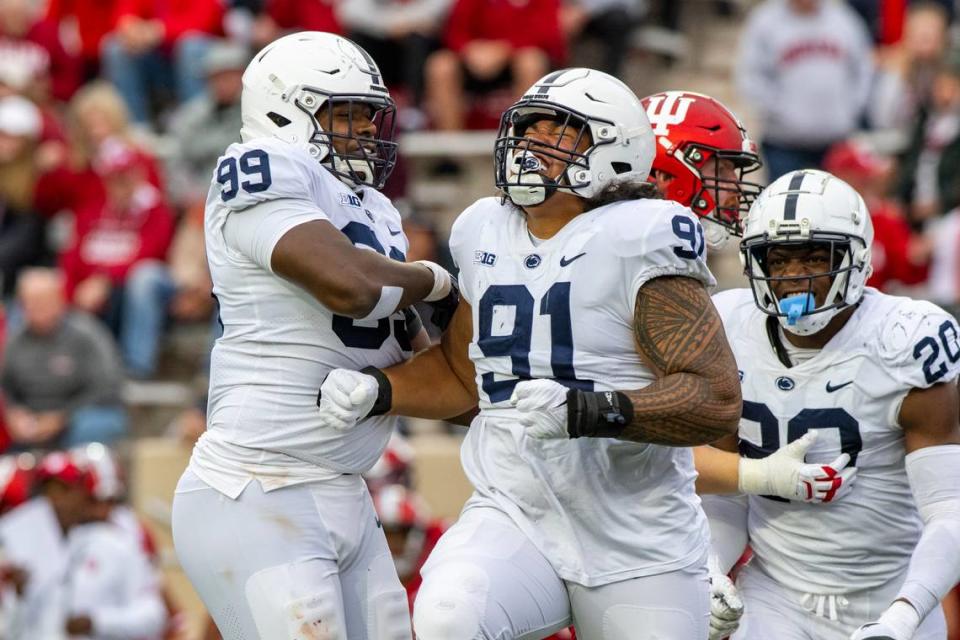 Penn State defensive tackle Dvon Ellies (91) reacts after taking Indiana quarterback Jack Tuttle (14) during an NCAA college football game, Saturday, Nov. 5, 2022, in Bloomington, Ind. (AP Photo/Doug McSchooler) Doug McSchooler/AP