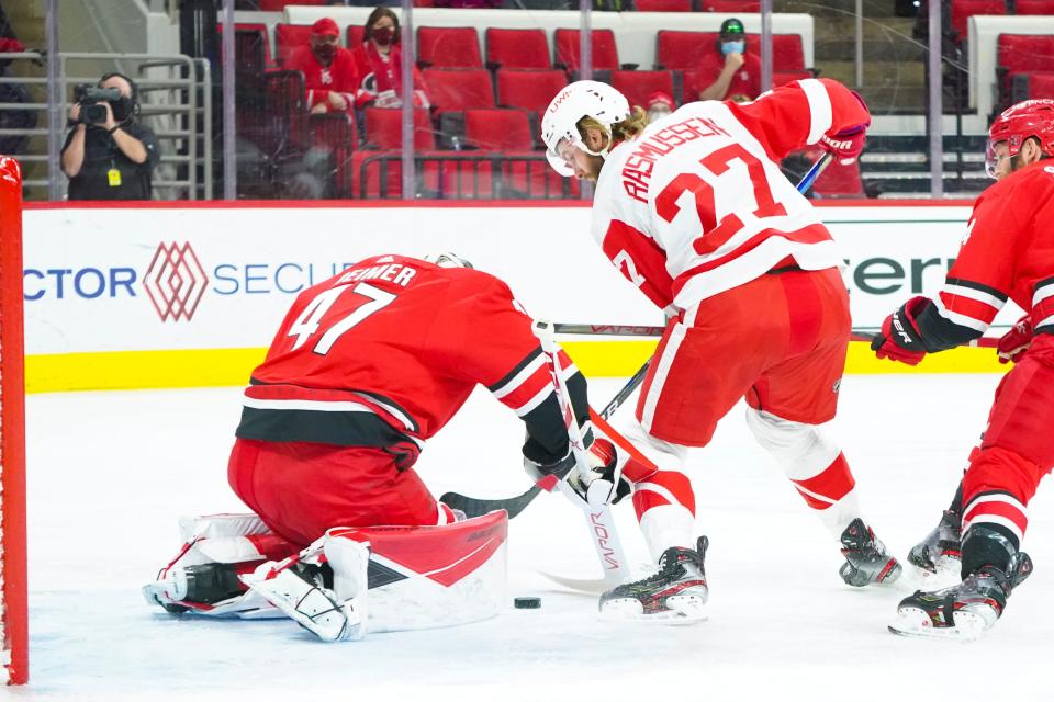 Carolina Hurricanes goaltender James Reimer (47) stops Detroit Red Wings center Michael Rasmussen (27) during the first period April 12, 2021 at PNC Arena.