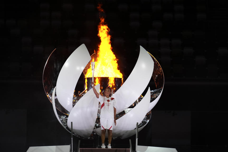 FILE - In this July 23, 2021, file photo, Japan's Naomi Osaka lights the cauldron during the opening ceremony in the Olympic Stadium at the 2020 Summer Olympics, in Tokyo, Japan. (AP Photo/Natacha Pisarenko, File)