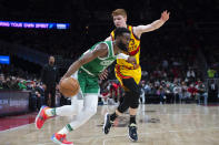 Boston Celtics guard Jaylen Brown (7) dribbles past Atlanta Hawks guard Kevin Huerter (3) during the first half of an NBA basketball game Friday, Jan. 28, 2022, in Atlanta. (AP Photo/Hakim Wright Sr.)