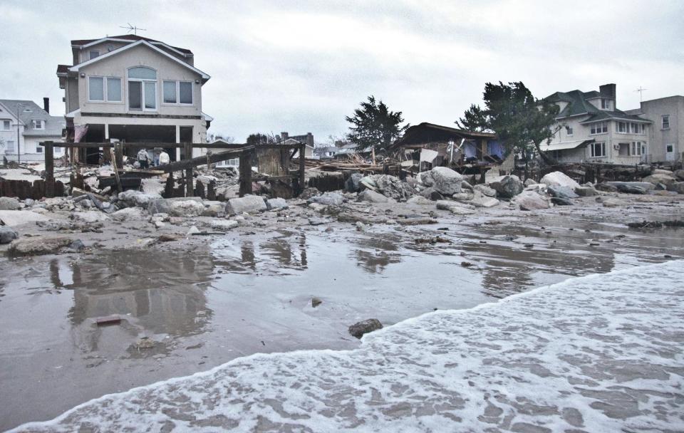 A beachfront house is damaged in the aftermath of yesterday's surge from superstorm Sandy, Tuesday, Oct. 30, 2012, in Coney Island's Sea Gate community in New York. (AP Photo/Bebeto Matthews)