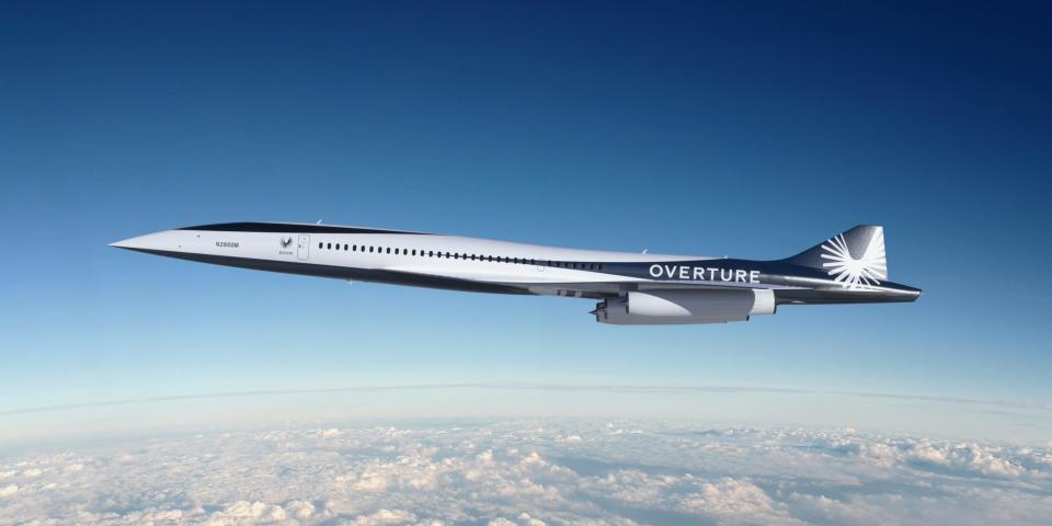 Boom Supersonic's Overture flying above clouds.