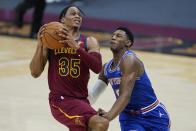 Cleveland Cavaliers' Isaac Okoro, left, drives to the basket against New York Knicks' RJ Barrett during the first half of an NBA basketball game, Friday, Jan. 15, 2021, in Cleveland. (AP Photo/Tony Dejak)