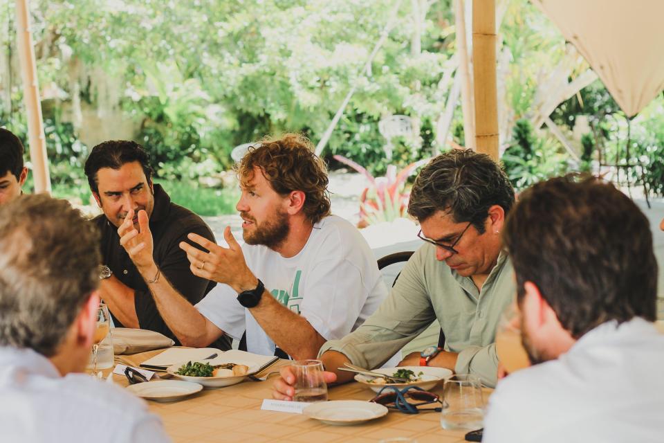 Formula 1 driver Sebastian Vettel (center) attended a climate change discussion at Plant the Future in Miami Shores on Thursday ahead of Sunday's Miami Grand Prix.