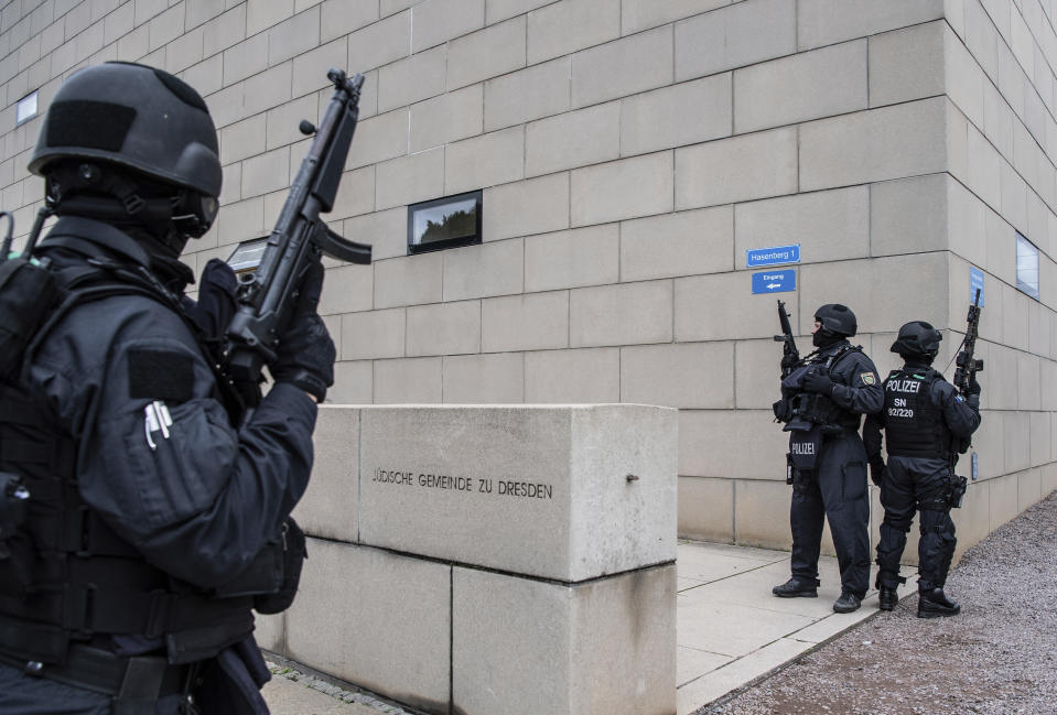 CORRECTS CITY TO DRESDEN -- Police officers secure a synagogue in Dresden, Germany, Wednesday, Oct. 9, 2019. One or more gunmen fired several shots on Wednesday in the German city of Halle. Police say a person has been arrested after a shooting that left two people dead. (Robert Michael/dpa via AP)