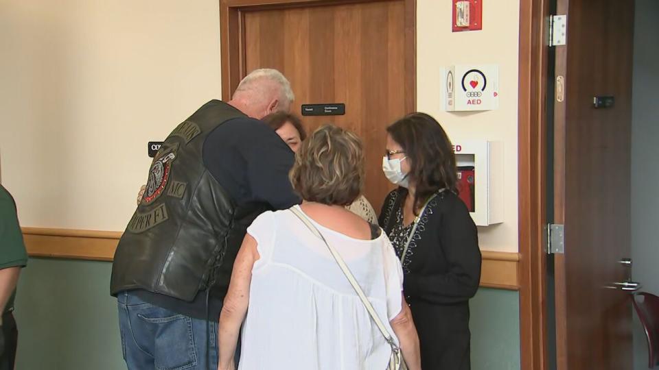 Family and friends of the seven motorcycle riders killed in the 2019 collision are seen hugging each other outside of court after the not guilty verdicts were read.