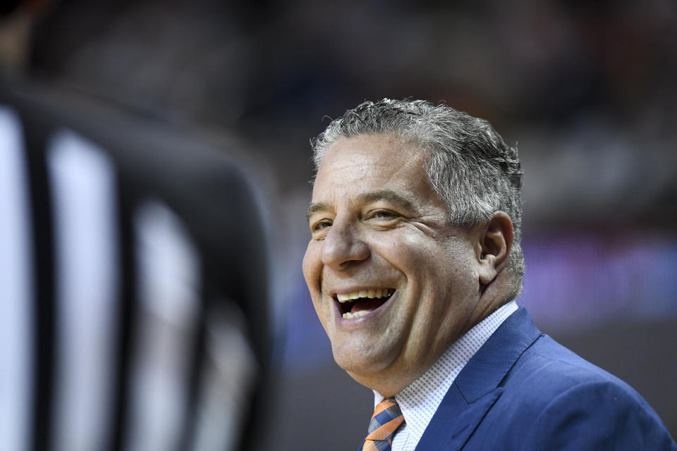 Auburn head coach Bruce Pearl smiles at an official during the first half of an NCAA college basketball game against Tennessee Saturday, Feb. 22, 2020, in Auburn, Ala. (AP Photo/Julie Bennett)