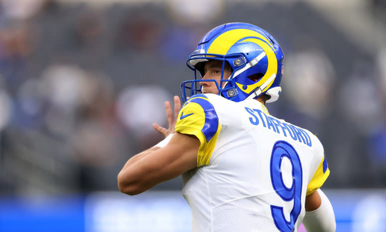 Matthew Stafford warms up on the field.