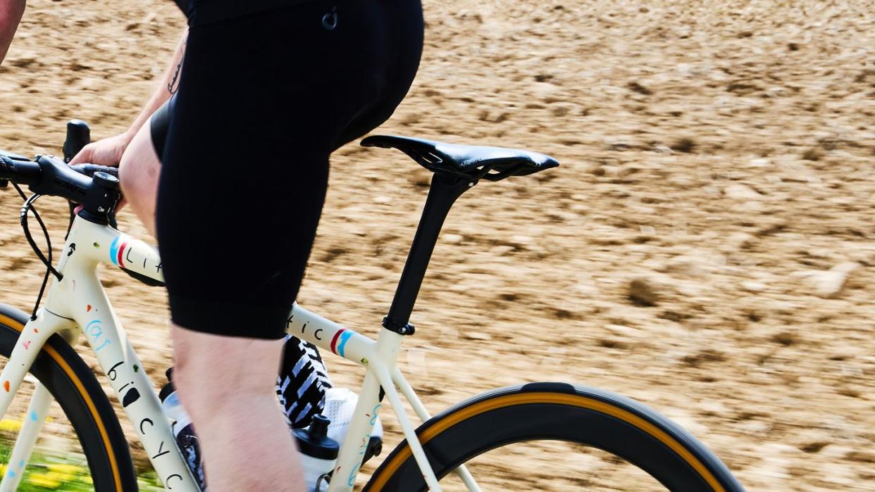 a person riding a bike out of the saddle