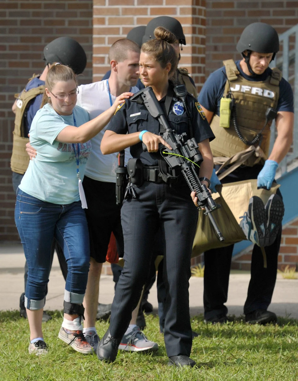 JSO officer J. Scott escorts &quot;victims&quot; to the waiting ambulances during a 2018 active shooter drill at First Coast High School.