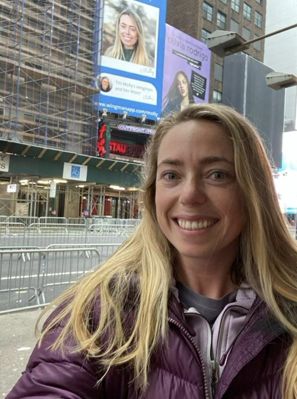 Molly Davis in front of her billboard.