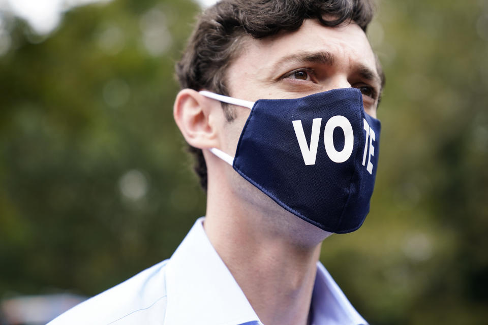 Democratic candidate for Senate Jon Ossoff watches during a "Get Out the Early Vote" event at the SluttyVegan ATL restaurant on Tuesday, Oct. 27, 2020, in Jonesboro, Ga. (AP Photo/Brynn Anderson)