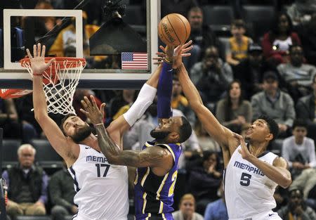 Feb 25, 2019; Memphis, TN, USA; Los Angeles Lakers forward LeBron James (23) goes to the basket against Memphis Grizzlies forward Bruno Caboclo (5) and Memphis Grizzlies center Jonas Valanciunas (17) during the second half at FedExForum. Mandatory Credit: Justin Ford-USA TODAY Sports