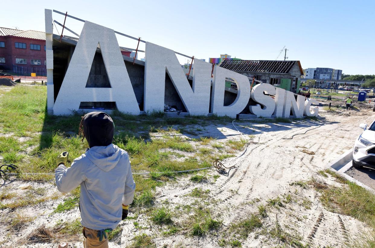 This October 2023 photo shows work continuing on "Lift Ev'ry Voice and Sing Park" in the LaVilla neighborhood. One of three surviving LaVilla shotgun houses has been moved to the site, next to a gathering spot created with giant letters spelling out the song title that is the park's namesake. Located at Adams and Lee streets, the park will celebrate James Weldon Johnson and John Rosamond Johnson, who were born in Jacksonville and wrote what is now known as the Black national anthem.