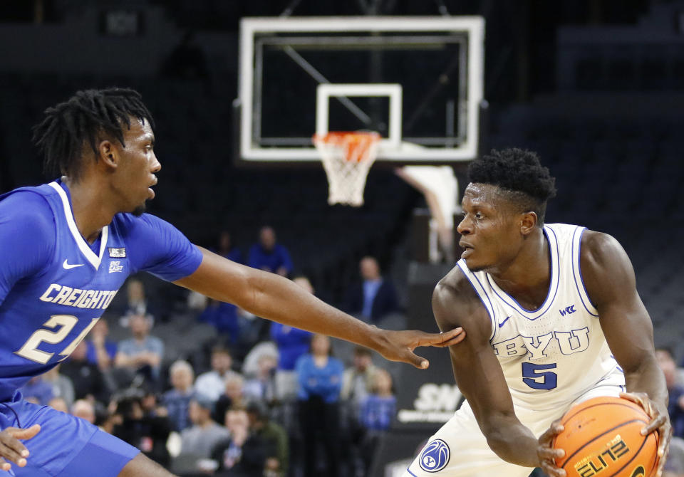 BYU forward Gideon George (5), right, squares off with Creighton forward Arthur Kaluma (24) during the second half of an NCAA college basketball game Saturday, Dec. 10, 2022, in Las Vegas. BYU won 83 to 80. (AP Photo/Ronda Churchill)