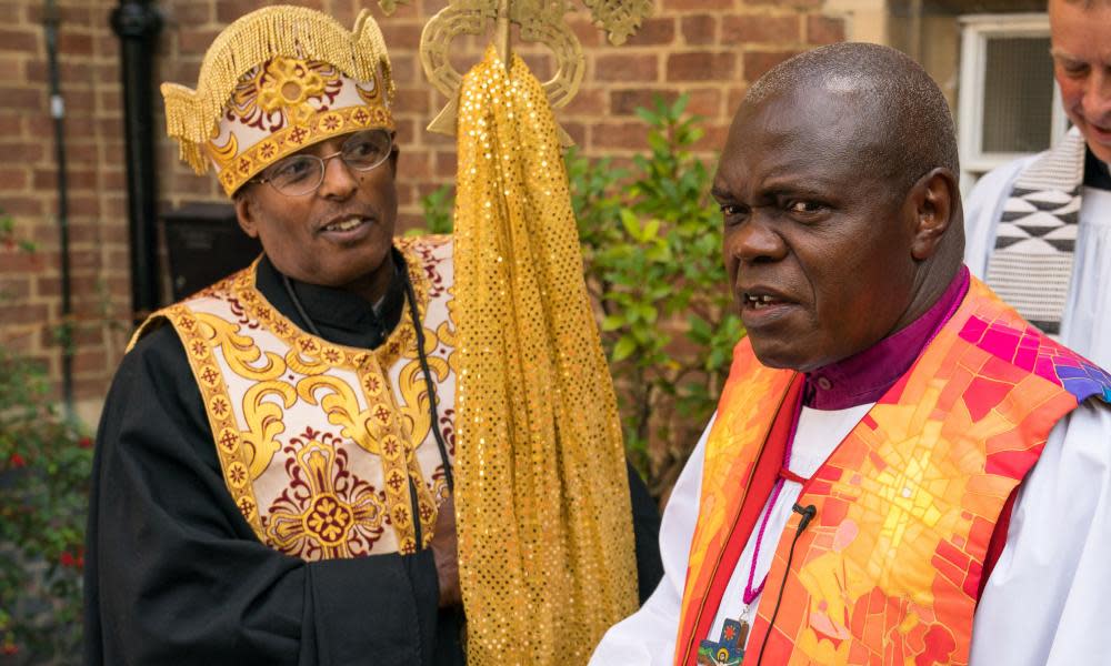 John Sentamu (right), greets Father Georgia Dimtsu of St Gabriel’s Ethiopian Orthodox Church at the service.