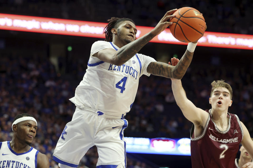 Kentucky's Daimion Collins (4) pulls down a rebound next to Bellarmine's Alec Pfriem (2) during the second half of an NCAA college basketball game in Lexington, Ky., Tuesday, Nov. 29, 2022. (AP Photo/James Crisp)