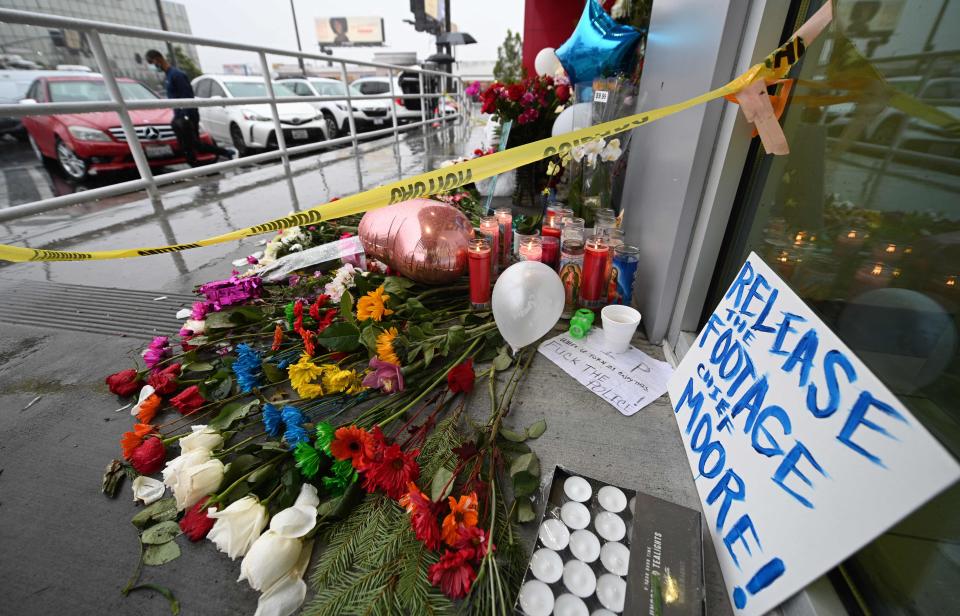 Flowers and baloons are left along with a sign reading "Release the Footage Moore" at a makeshift memorial for the teenage girl who was killed by a police stray bullet at a Burlington coat factory in North Hollywood, California, December 27, 2021. - Bodycam footage of the "chaotic" police shooting of a teenager in a crowded California department store was expected to be released Monday, as criticism swelled that officers were all-too-ready to open fire.Fourteen-year-old Valentina Orellana-Peralta was trying on clothes in a changing room when a stray bullet came through the wall and hit her, killing her instantly on December 23. (Photo by Robyn Beck / AFP) (Photo by ROBYN BECK/AFP via Getty Images) ORG XMIT: 0 ORIG FILE ID: AFP_9VA8PV.jpg