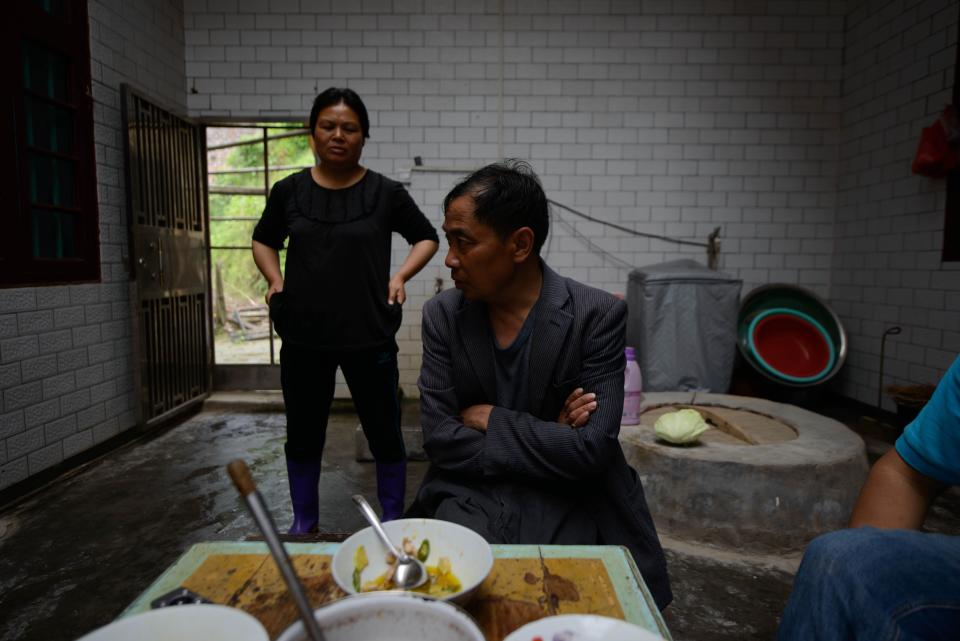 A former construction worker sits with his wife in their house in the village of Shuangxi, Hunan province in 2013.