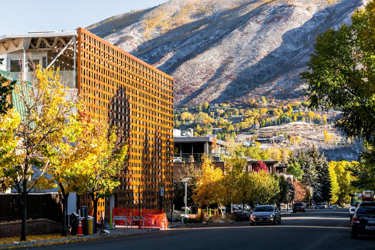 Downtown Aspen, Colorado during autumn, yellow aspen trees and snowy mountain in the background