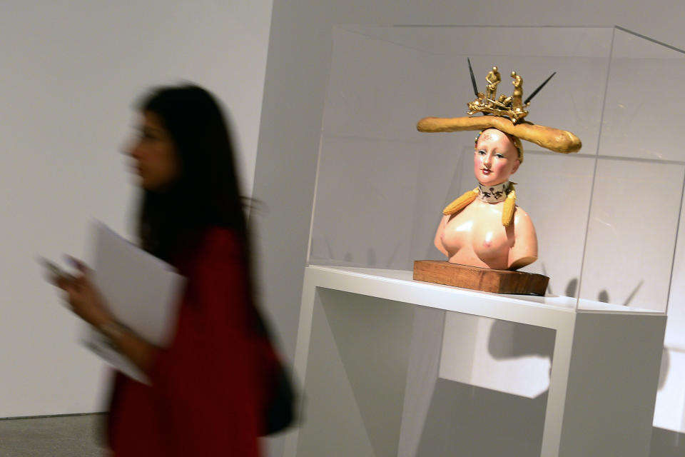 A woman walks past a sculpture entitled 'Retrospective Bust of a Woman' by Spanish surrealist artist Salvador Dali during the exhibition 'Dali. All of the poetic suggestions and all of the plastic possibilities' at the Reina Sofia museum in Madrid on April 25, 2013.  (JAVIER SORIANO/AFP/Getty Images)