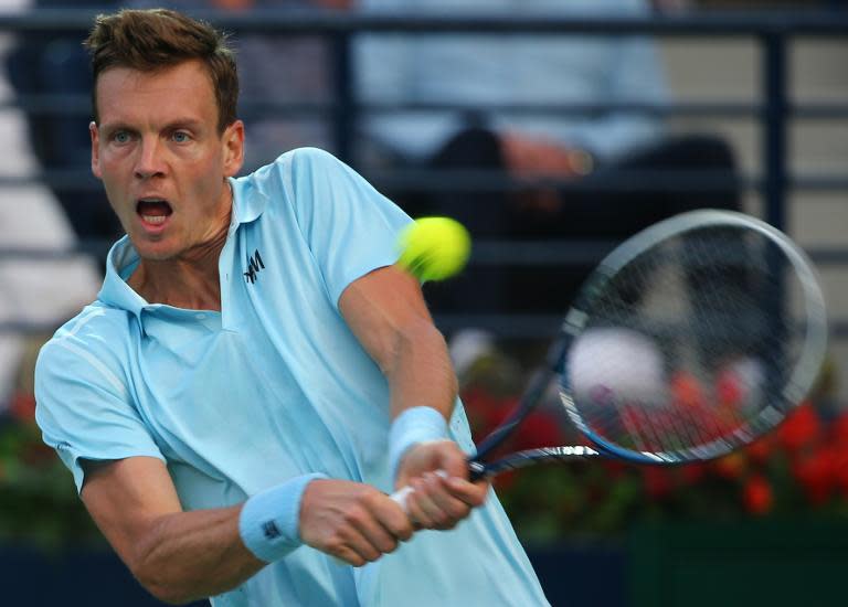 Tennis player Tomas Berdych of the Czech Republic returns the ball to Sergiy Stakhovsky of Ukraine during their quarter final match on the fourth day of the ATP Dubai Duty Free Tennis Championships on February 26, 2015 in Dubai