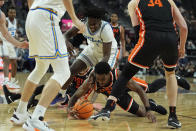 UCLA guard Will McClendon, top, and Oregon State guard Justin Rochelin scramble for the ball during the second half of an NCAA college basketball game in the first round of the Pac-12 tournament Wednesday, March 13, 2024, in Las Vegas. (AP Photo/John Locher)