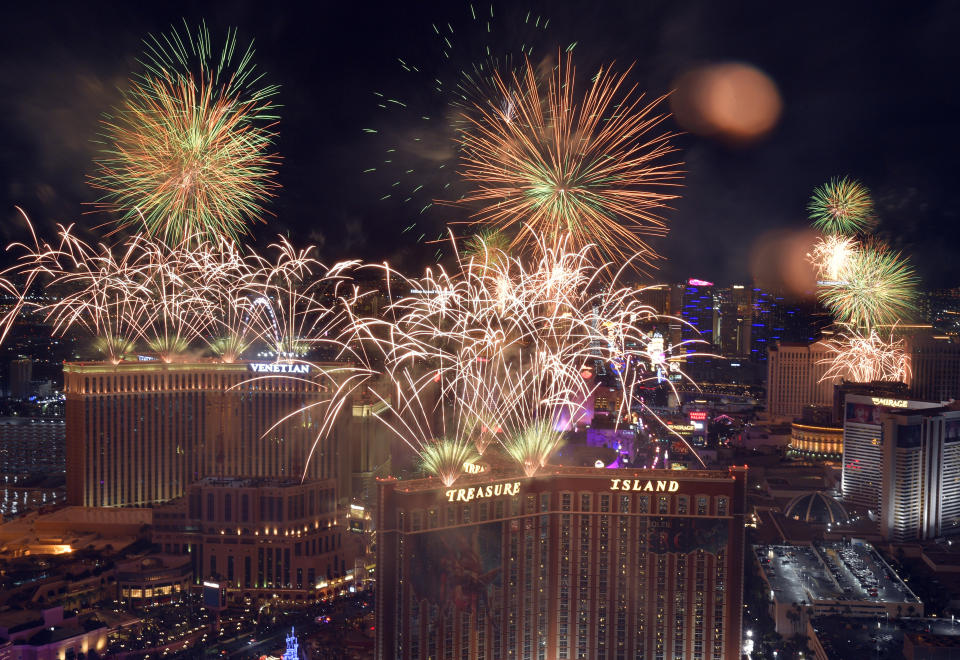 FILE - Fireworks explode over the Las Vegas Strip during a New Year's Eve celebration Jan 1, 2023, in Las Vegas. Tens of thousands of Vegas Golden Knights fans, maybe more, are expected at the heart of the Las Vegas Strip on Saturday for a Stanley Cup victory parade and a rally to mark the team’s first-ever NHL championship. Las Vegas police prepared Friday for upwards of 100,000 people to cram viewing areas along Las Vegas Boulevard for a celebration that planners were comparing to annual New Year’s Eve fireworks shows. (AP Photo/David Becker, File)