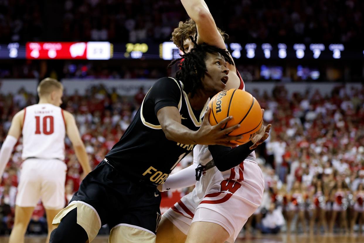 Wake Forest's Tyree Appleby  goes around Wisconsin's Max Klesmit to score two of his game-high 32 points Tuesday night at the Kohl Center.