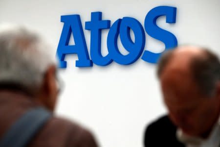 People walk in front of the Atos company's logo in Paris, France, April 12, 2016. REUTERS/Philippe Wojazer/File Photo