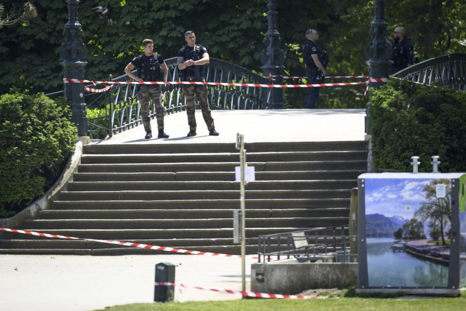 CORRECTS SLUG - Security forces gather at the scene of knife attack in Annecy, French Alps, Thursday, June 8, 2023. An attacker with a knife stabbed several young children and at least one adult, leaving some with life-threatening injuries, in a town in the Alps on Thursday before he was arrested, authorities said. (Jean-Christophe Bott/Keystone via AP)