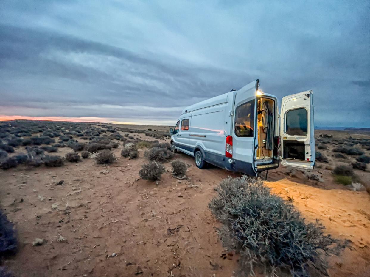 Camper Van Situated in the Northern Arizona Desert near Monument Valley Tribal Park under a dramatic sky wild camping or boondocking